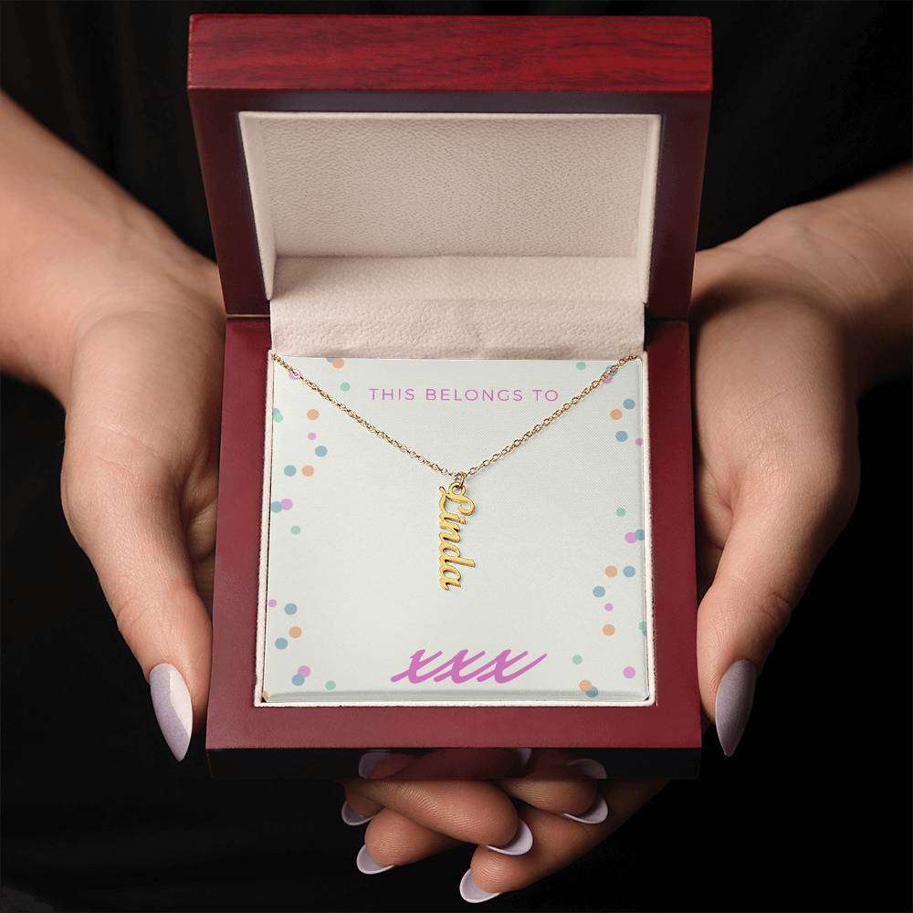 Vertical personalized name necklace in gift box with cursive gold design.