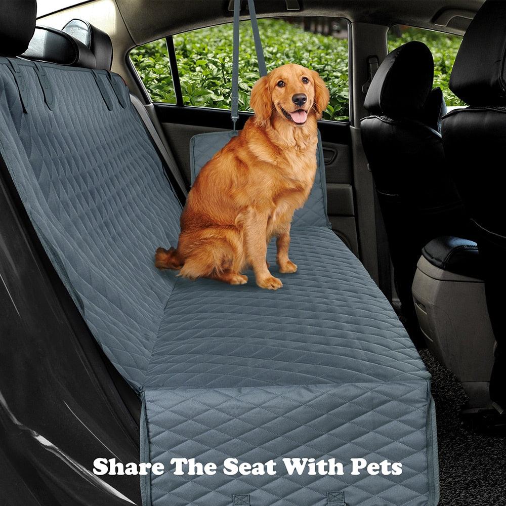 Dog sitting on a durable, gray car seat cover, designed for protection and comfort.
