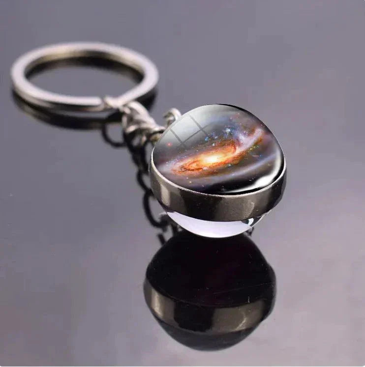 The Planets in The Solar System & Planets Key Ring solar System Planet Key Ring with sleek, durable zinc alloy design on reflective surface.