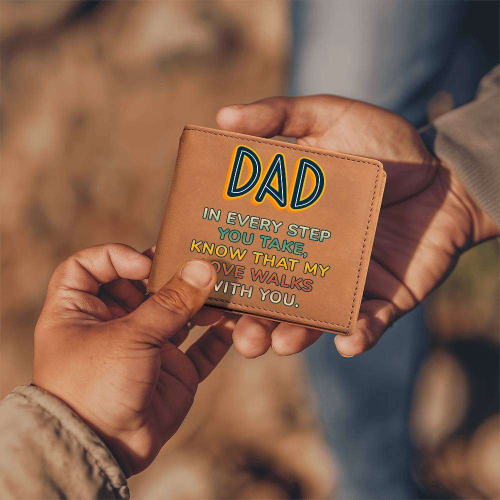 Leather wallet with "Dad In Every Step You Take" printed on front, held in hands, outdoor background.