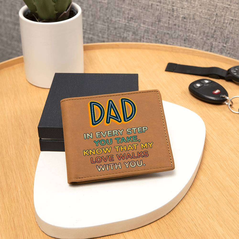 Brown leather wallet with "Dad In Every Step You Take" design, displayed on a table near a gift box.