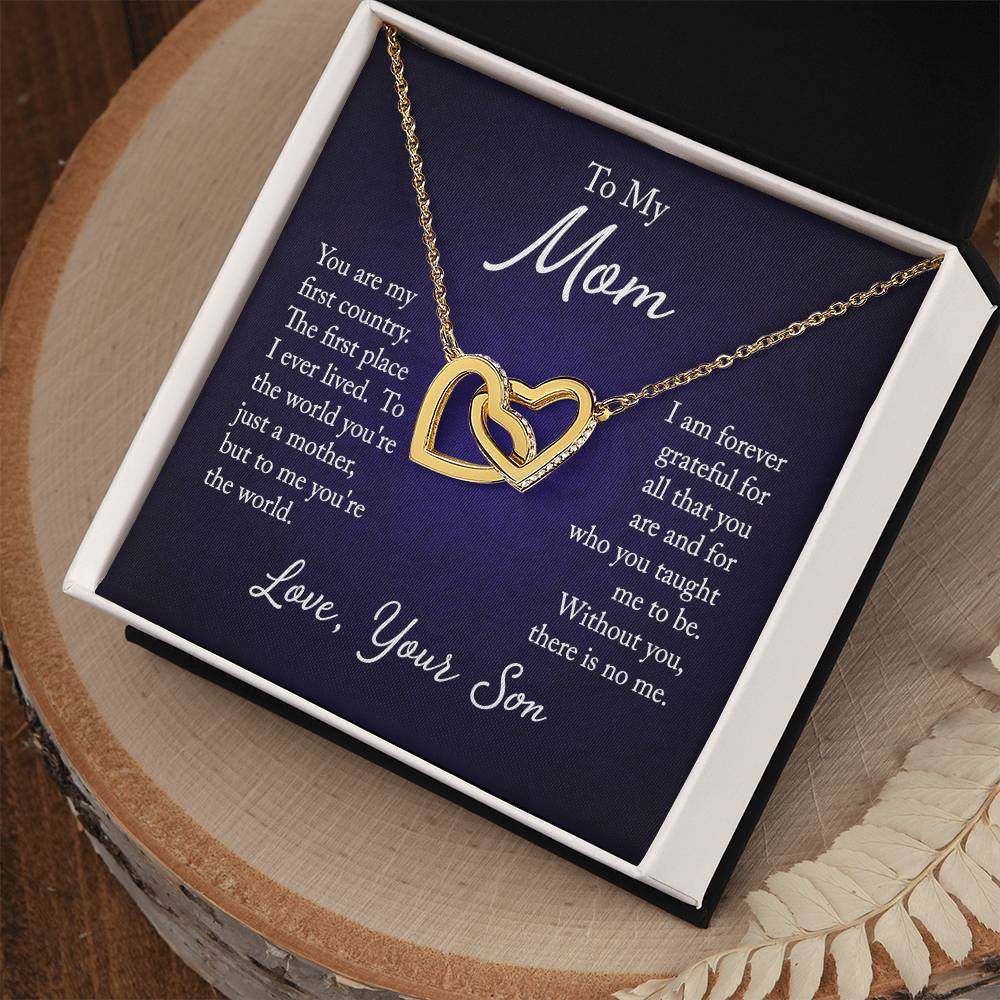 Interlocking hearts necklace for mom from son with CZ crystals on a polished metal chain, displayed in a gift box with a heartfelt message.