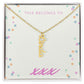 Vertical personalized name necklace in a gift box with cursive design and gold chain.