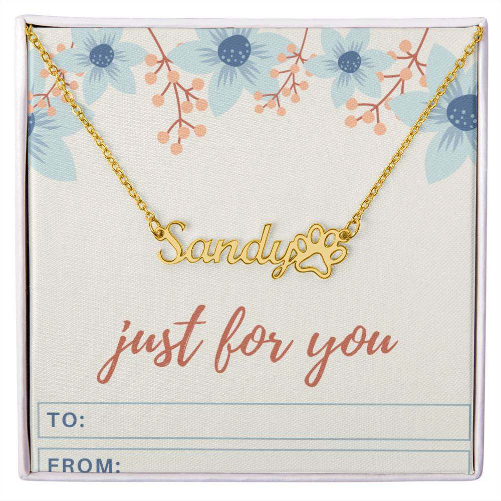 Personalized name necklace with paw print charm on floral background.