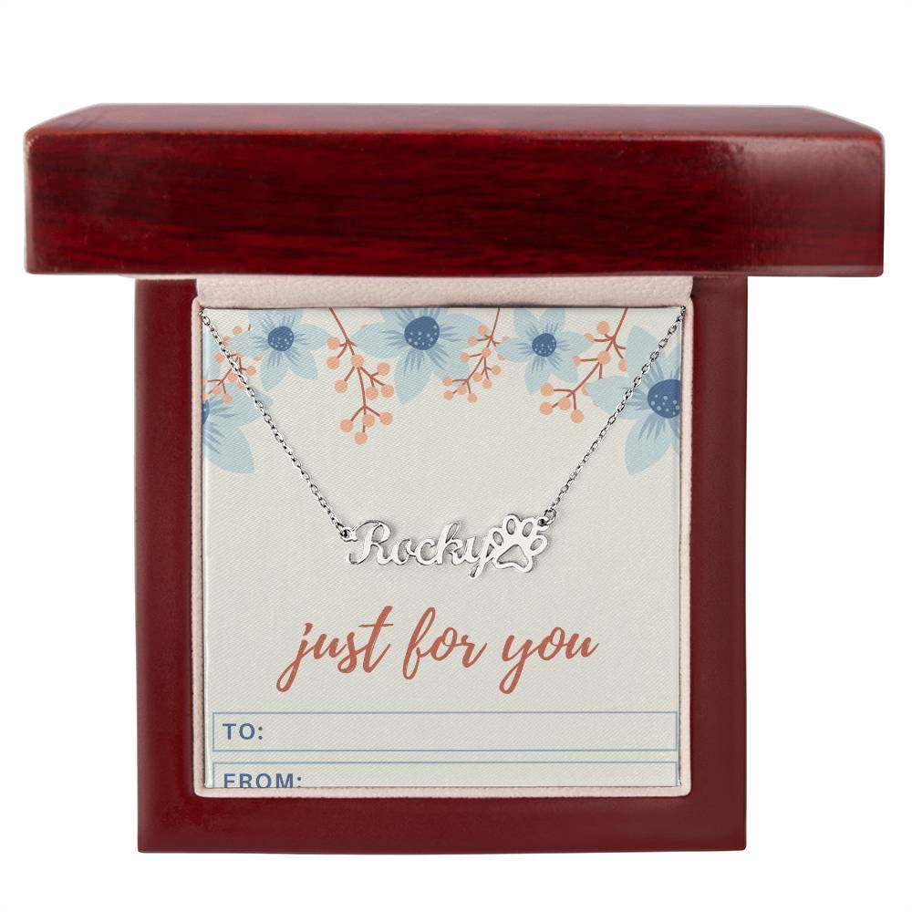 Personalized name necklace with paw print charm displayed in a gift box.